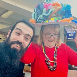 Photo of Mikey with Carol with her hat