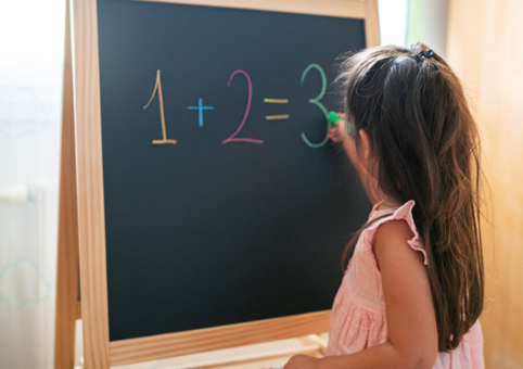 Child writing on blackboard