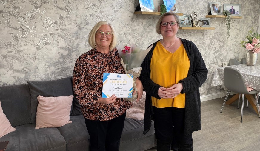 Tina Driscoll receiving her certificate and flowers from Cllr Lorna Fielker