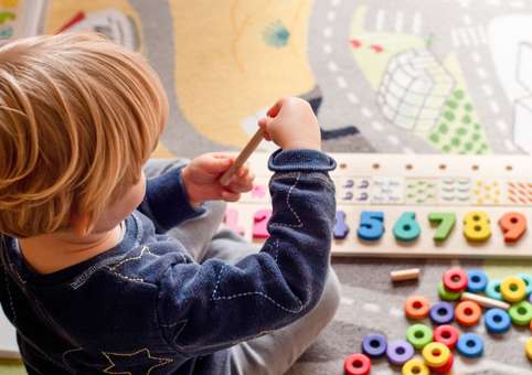 Child playing with a numbers toy