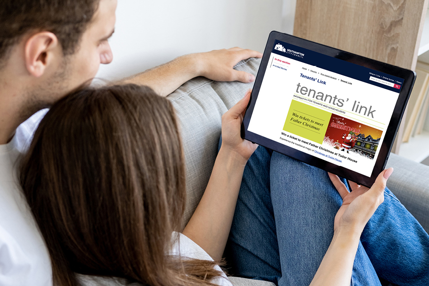 A man and a woman reading Tenants' Link together