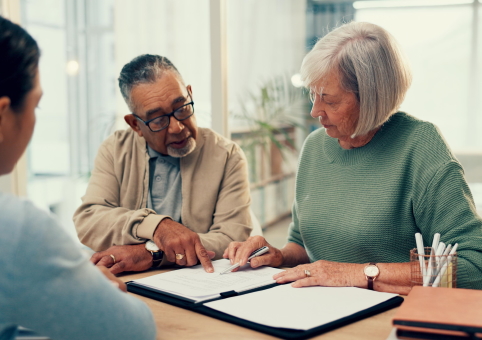 Couple looking over legal documents with a lawyer