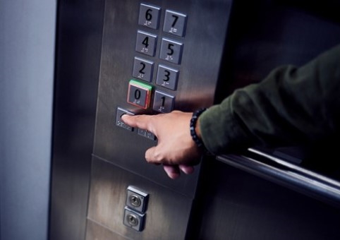 Lift button being pressed