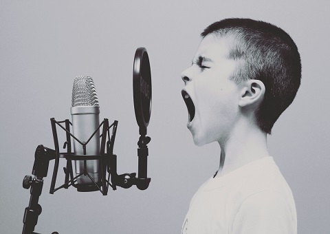 Boy screaming into microphone