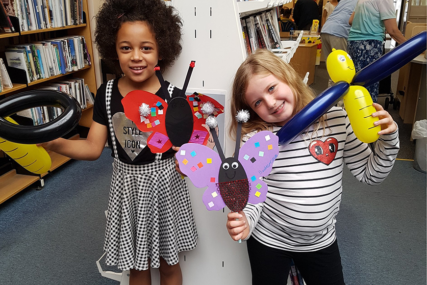 Two children having fun at the library