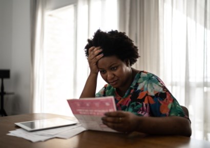 Woman looking anxious over bill