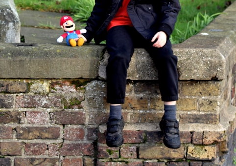 A child sitting on a wall
