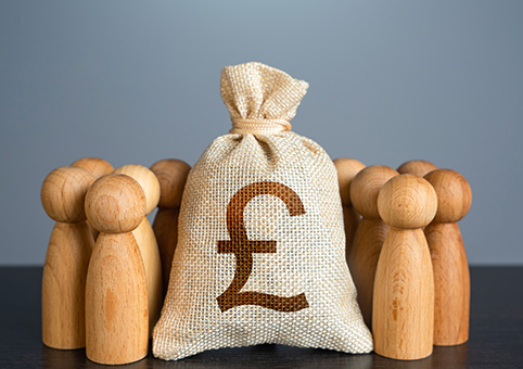 Wooden figures around a bag with a pound symbol on it