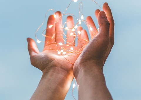 Hands holding fairy lights