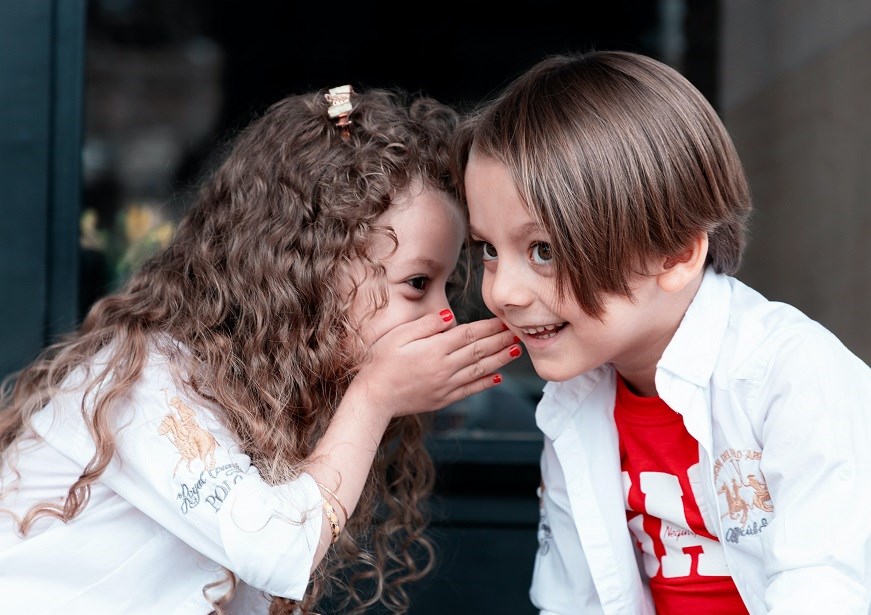 Two young children talking to each other