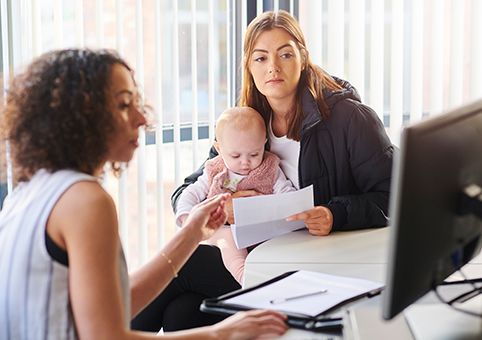 Mother and child with a professional looking at a screen