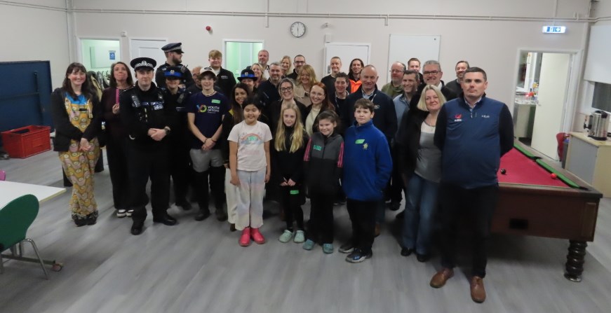 A group of people, including the Police, in the games room