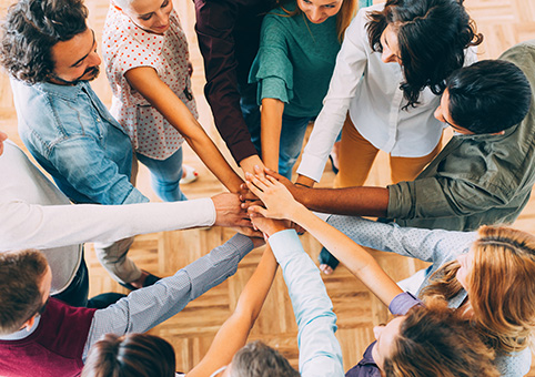 People in a circle putting their hands in