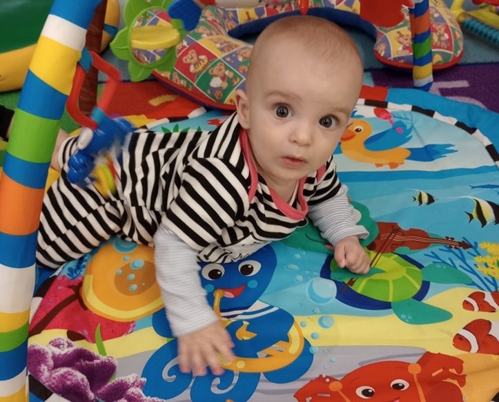 Baby crawling on a play mat