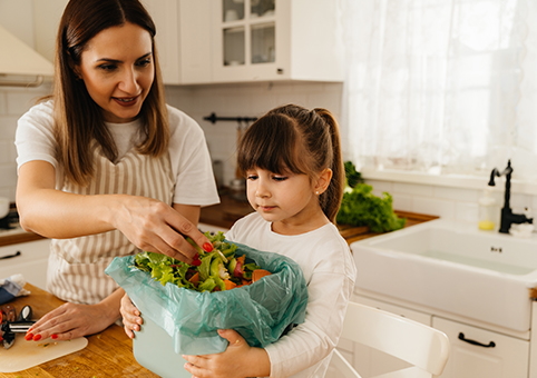 Woman and child using food caddy