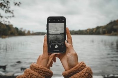 Person taking a picture of flooding on a phone