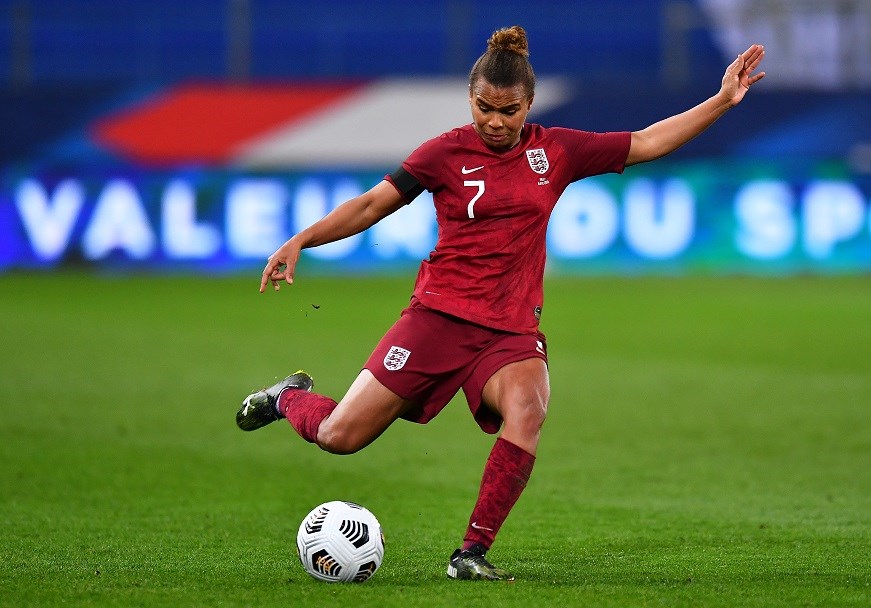 English woman footballer about to kick the ball