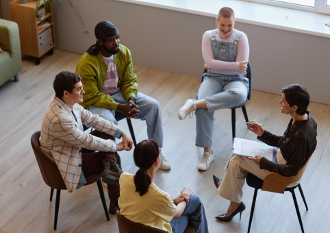 People sat in circle of chairs