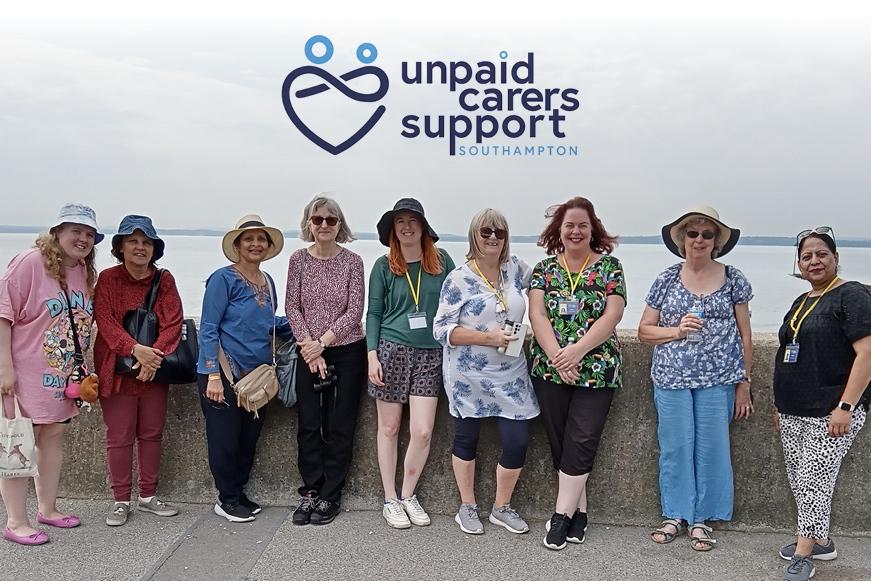 Nine women posing for a photograph with text "Unpaid Carers Support Southampton"