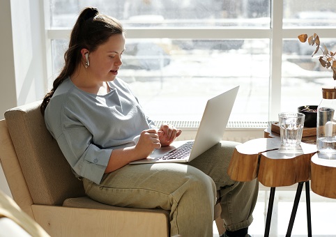 Someone looking at a laptop