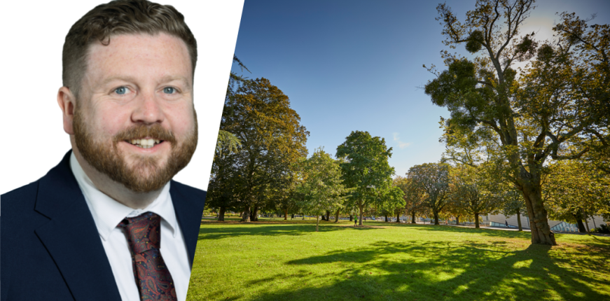 Leader next to image of a park