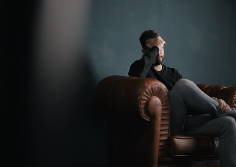 Depressed man in darkened room