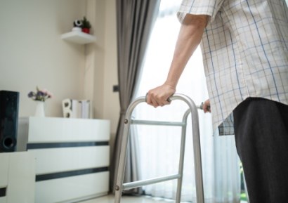 Man using Zimmer frame in house