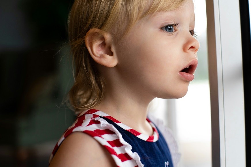 Young child looking out of window