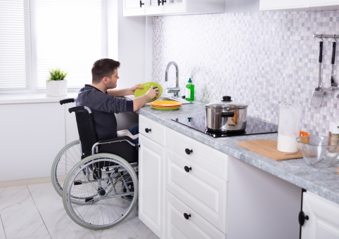 Man in wheelchair in adapted kitchen