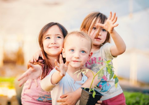 Three children reaching out 