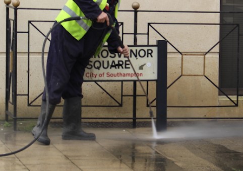 Someone power washing the street