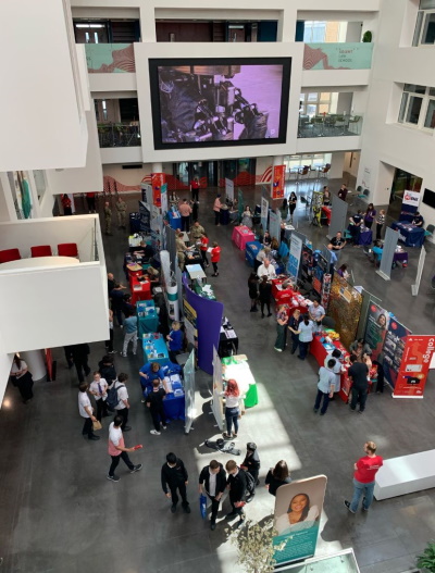 Exhibitors and attendees at the Your Future event. There are numerous people and stands