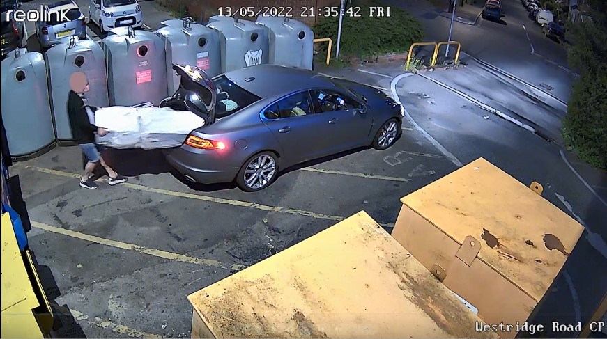 A man removing a large item from a car boot at Westridge Road car park. Text says: 'Reolink. 13/05/2022 21:35:42 Fri.'