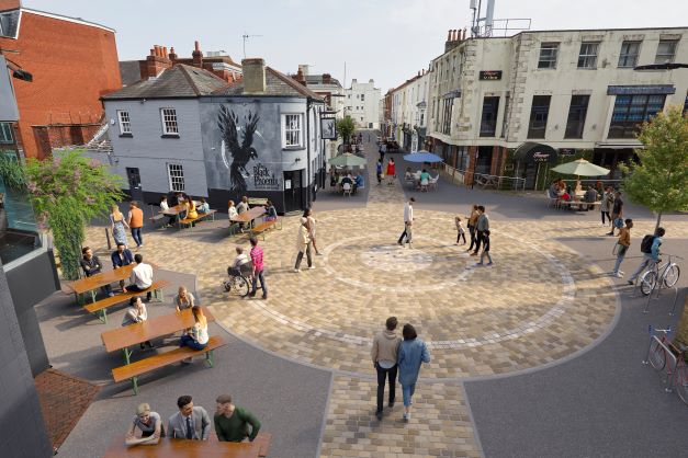 Computer generated image of development showing people moving around a paved area and sitting at picnic benches