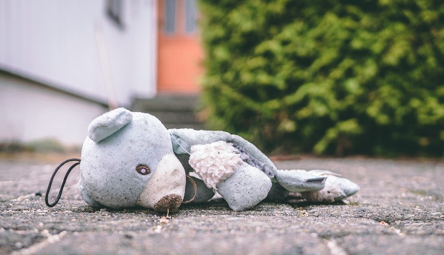 Torn teddy bear on ground