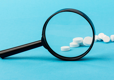 Magnifying glass in front of tablets