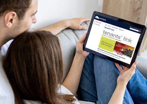 Two people looking at Tenants' Link on a tablet