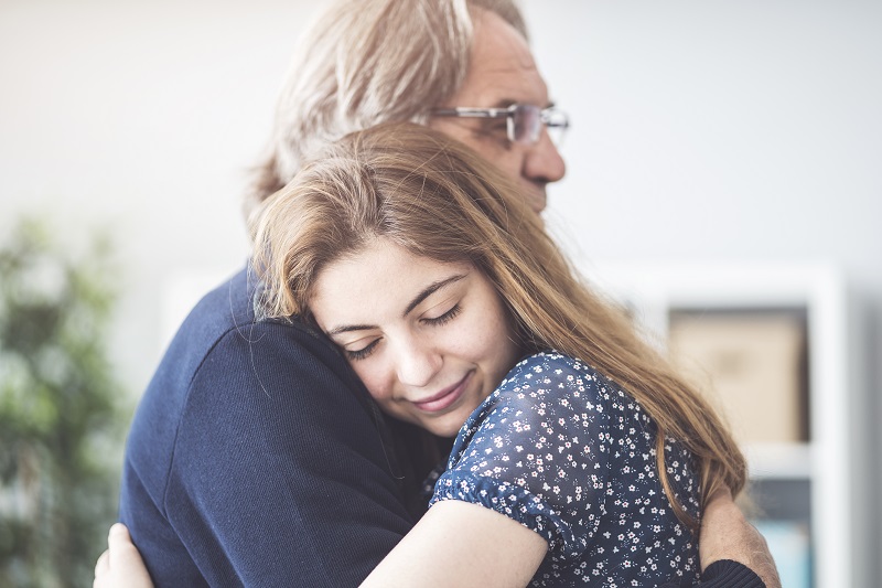 A man and a girl embracing