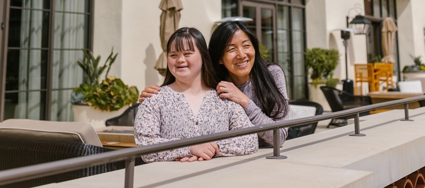 A mother and a daughter on a balcony