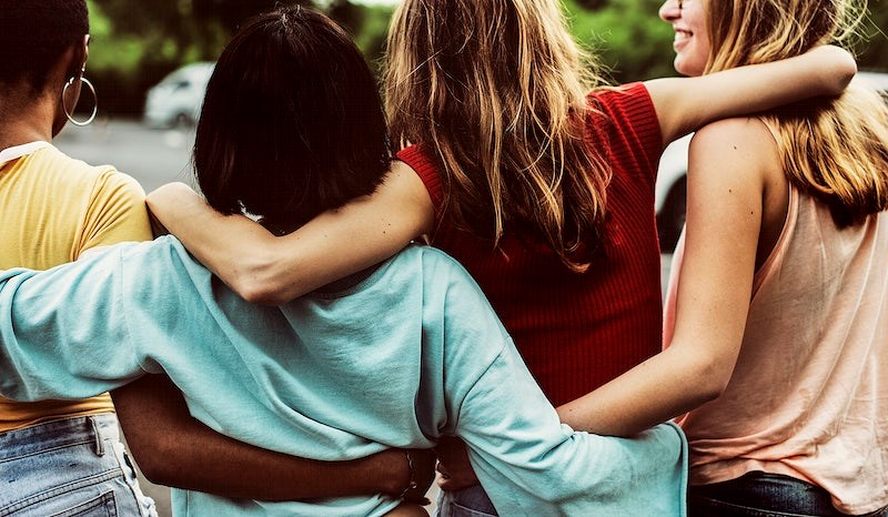 Group of people with arms around each other