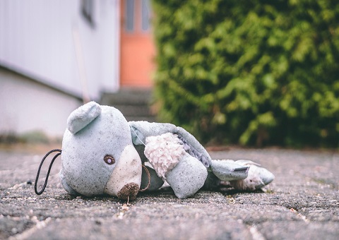 A teddy bear lying on the road