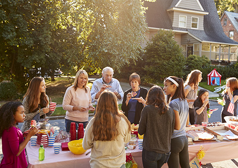 People eating around a table at a street party