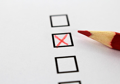 Red pencil and a cross in a checkbox