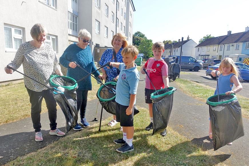 A group of people picking litter A group of people picking litter