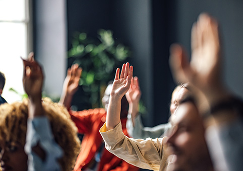 Group of people with hands raised