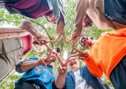 A group of people holding hands together in peace symbols