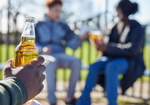 People drinking in a park