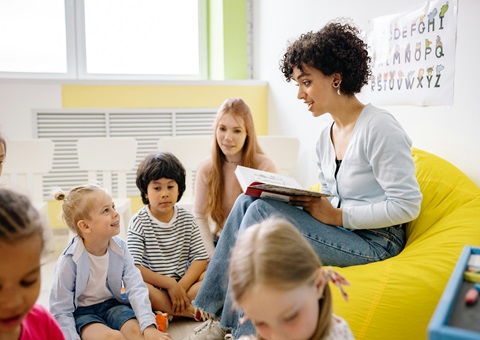 Teacher reading to young children