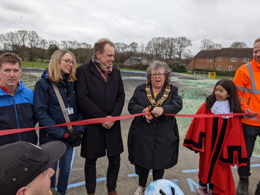 A ribbon cutting ceremony. The Lord Mayor is cutting the ribbon.