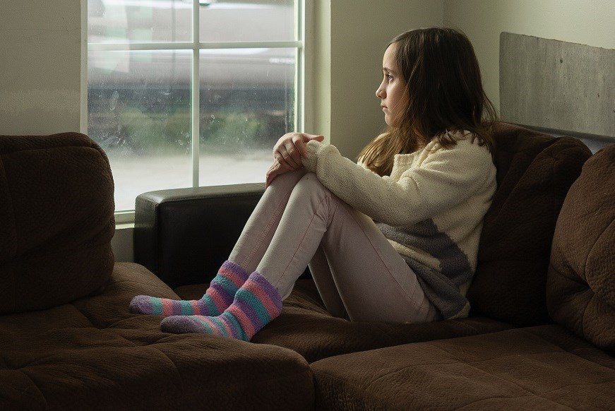 Girl sitting and looking out of window